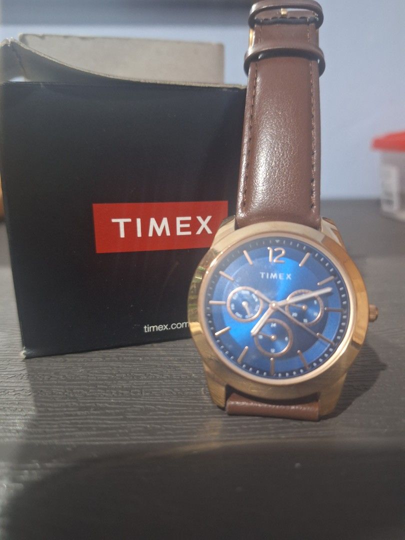 Timex Quartz Watch with Blue Dial and Brown Leather Strap (Category: Men's Watches) located in Mandaluyong City. Submitted by khute08 (Listing ID 1466448332, Image 1). Description: preloved: used 2 - 3x only. - Brand: Timex - Movement: Quartz - Dial: Striking blue with day and date sub-dials - Case: Gold-tone - Strap: Brown leather with buckle closure (minor wear on inner lining near adjustment holes) - Inclusion: Original black Timex box with re