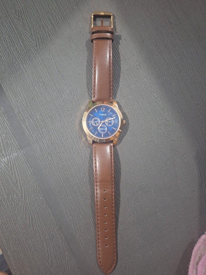 Timex Quartz Watch with Blue Dial and Brown Leather Strap (Category: Men's Watches) located in Mandaluyong City. Submitted by khute08 (Listing ID 1466448332, Image 2). Description: preloved: used 2 - 3x only. - Brand: Timex - Movement: Quartz - Dial: Striking blue with day and date sub-dials - Case: Gold-tone - Strap: Brown leather with buckle closure (minor wear on inner lining near adjustment holes) - Inclusion: Original black Timex box with re