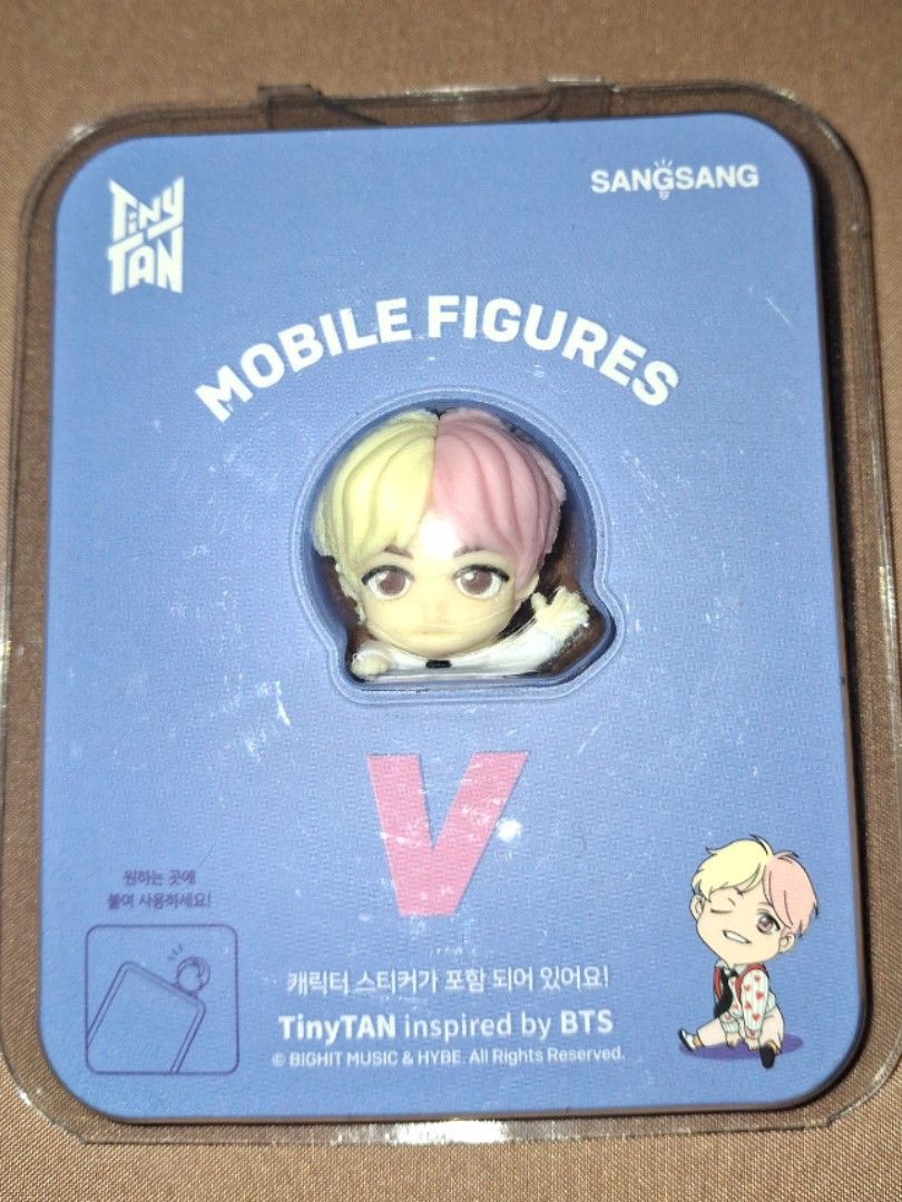 TinyTAN V Mobile Figure SangSang BTS Official (Category: Designer & Blind Box Toys) located in Cavite. Submitted by 92939494959597 (Listing ID 1466419791, Image 1). Description: - Official SangSang BTS TinyTAN mobile figure featuring member V (Runnin' Man look) - Eye-catching pink and yellow hair design - Compact size: 25 x 40mm, made of durable PVC material - Brand new and sealed in original blister pack with backing card - 100% authentic mercha
