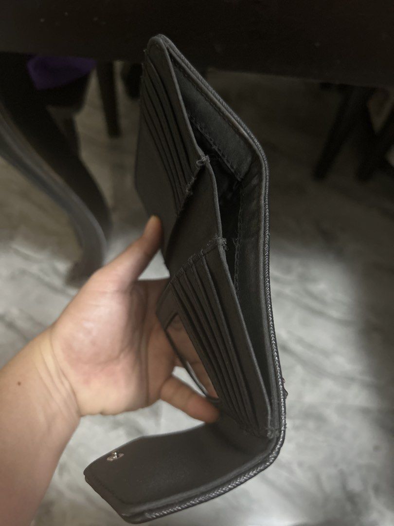 Tommy Hilfiger Black Trifold Wallet (Category: Wallets & Card holders) located in Gapan. Submitted by mysticrabbit-3195 (Listing ID 1466473849, Image 3). Description: - Brand: Tommy Hilfiger - Color: Classic Black - Material: Textured faux leather with silver-tone TH logo badge - Closure: Secure snap button - Interior: Multiple card slots, clear ID window, and spacious cash compartments - Exterior: Back zipped coin pocket with a branded zipper pu