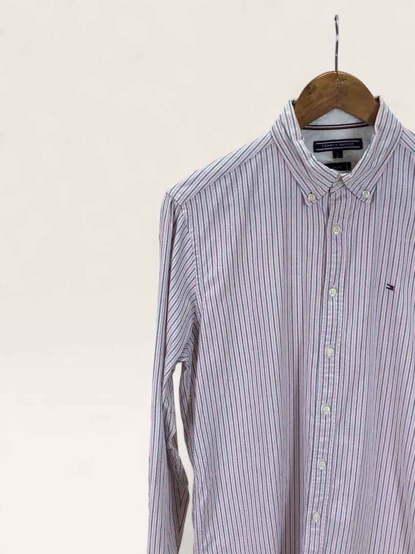 Tommy Hilfiger Striped Stretch Button-Down Shirt Size S (Category: Formal Shirts) located in Manila. Submitted by 12essentials (Listing ID 1466437385, Image 2). Description: 📌 Excellent Condition 📌 S on Tag 📌 Length 29’ Width 20’ Tommy Hilfiger long sleeve button-down shirt in a pink, white, and navy blue stripe pattern. Features stretch fabric, a button-down collar, and the signature embroidered flag logo. Size Small..
