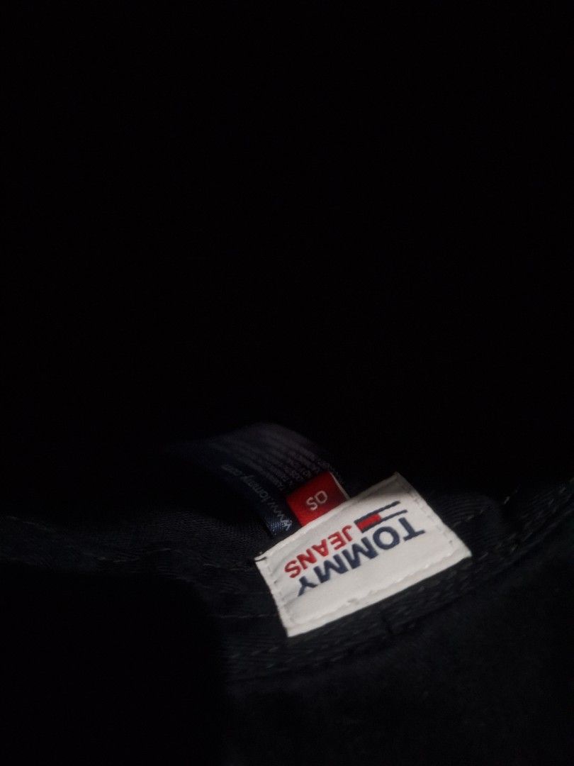 Tommy Jeans Navy Blue Bucket Hat OS (Category: Caps & Hats) located in Manila. Submitted by adolphreyes645 (Listing ID 1466539282, Image 2). Description: - Brand: Tommy Jeans - Color: Navy Blue - Size: OS (One Size) - Material: 100% Cotton - Design: Small embroidered flag logo on front, solid dark blue color - Features: Foldable and packable, classic streetwear style.