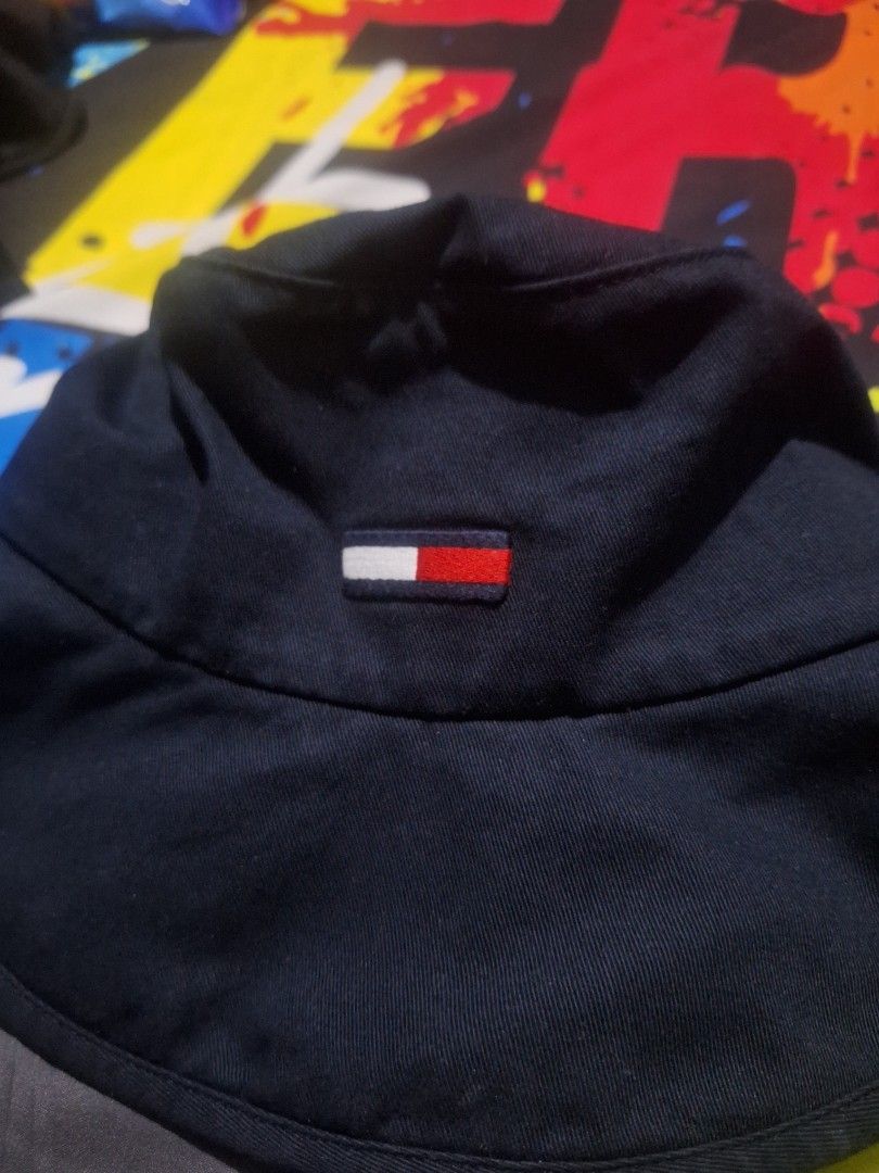 Tommy Jeans Navy Blue Bucket Hat OS (Category: Caps & Hats) located in Manila. Submitted by adolphreyes645 (Listing ID 1466539282, Image 3). Description: - Brand: Tommy Jeans - Color: Navy Blue - Size: OS (One Size) - Material: 100% Cotton - Design: Small embroidered flag logo on front, solid dark blue color - Features: Foldable and packable, classic streetwear style.