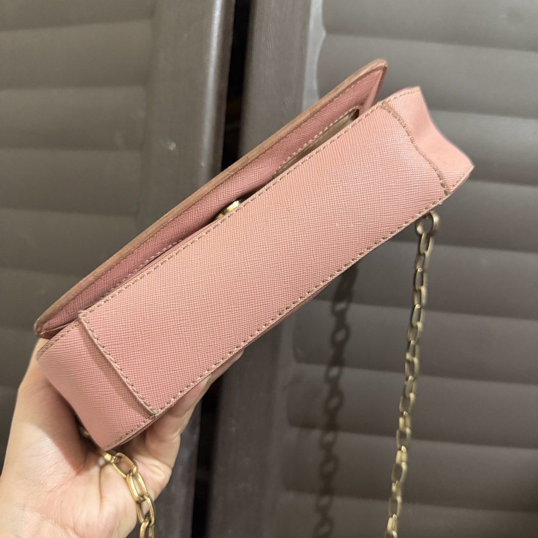 Tory Burch Pink Crossbody Bag (Category: Luxury Bags & Wallets) located in Rizal. Submitted by lovegclothingph (Listing ID 1466474964, Image 2). Description: - Brand: Tory Burch - Material: Durable pink Saffiano leather - Hardware: Gold-tone with matching chain strap and front logo clasp - Closure: Secure snap flap - Size: Compact, ideal for daily essentials - Condition: Pre-loved with minor edge wear and light hardware tarnish (please check phot
