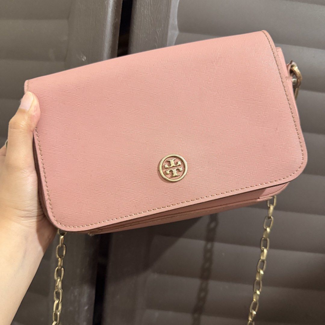 Tory Burch Pink Crossbody Bag (Category: Luxury Bags & Wallets) located in Rizal. Submitted by lovegclothingph (Listing ID 1466474964, Image 1). Description: - Brand: Tory Burch - Material: Durable pink Saffiano leather - Hardware: Gold-tone with matching chain strap and front logo clasp - Closure: Secure snap flap - Size: Compact, ideal for daily essentials - Condition: Pre-loved with minor edge wear and light hardware tarnish (please check phot