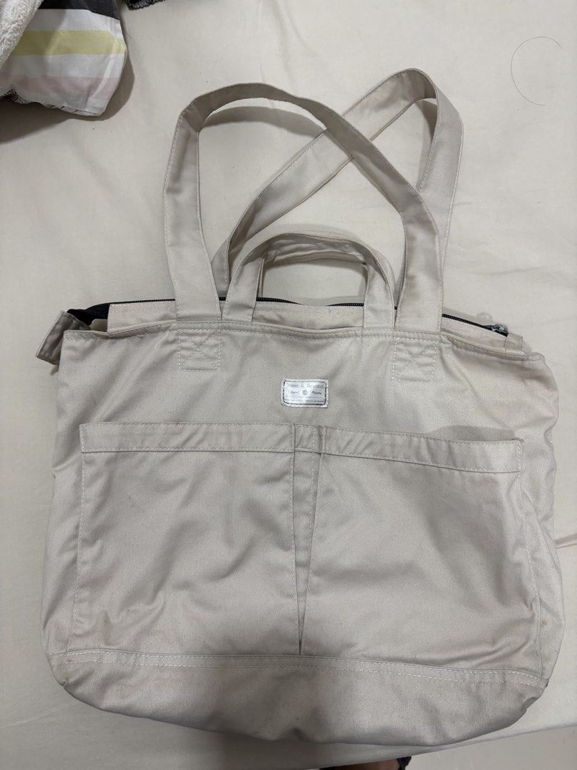 Totes & Beyond Canvas Tote Bag Off White (Category: Tote Bags) located in Mandaluyong City. Submitted by annab11 (Listing ID 1466562044, Image 1). Description: - Brand: Totes & Beyond - Color: Versatile off-white canvas - Carry options: Double hand handles and longer shoulder straps - Storage: Front patch pocket and roomy interior for books, essentials, or a laptop - Closure: Secure zip top - Condition: Minor signs of wear on the fabric.