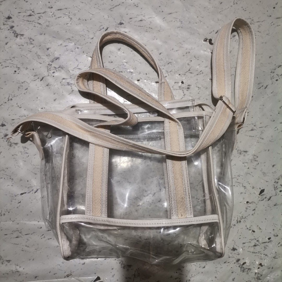 Transparent Bag (Category: Cross-body Bags) located in Pasig City. Submitted by reyning (Listing ID 1466507194, Image 3). Description: 👜 transparent PVC tote features durable cream-colored canvas webbing handles and an adjustable shoulder strap 👜 Medium size.
