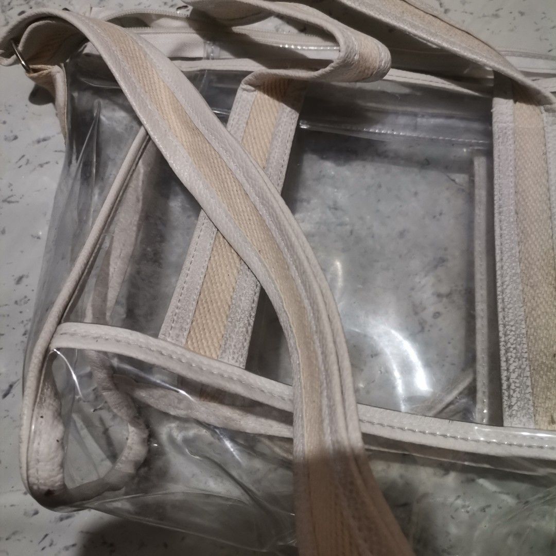 Transparent Bag (Category: Cross-body Bags) located in Pasig City. Submitted by reyning (Listing ID 1466507194, Image 2). Description: 👜 transparent PVC tote features durable cream-colored canvas webbing handles and an adjustable shoulder strap 👜 Medium size.