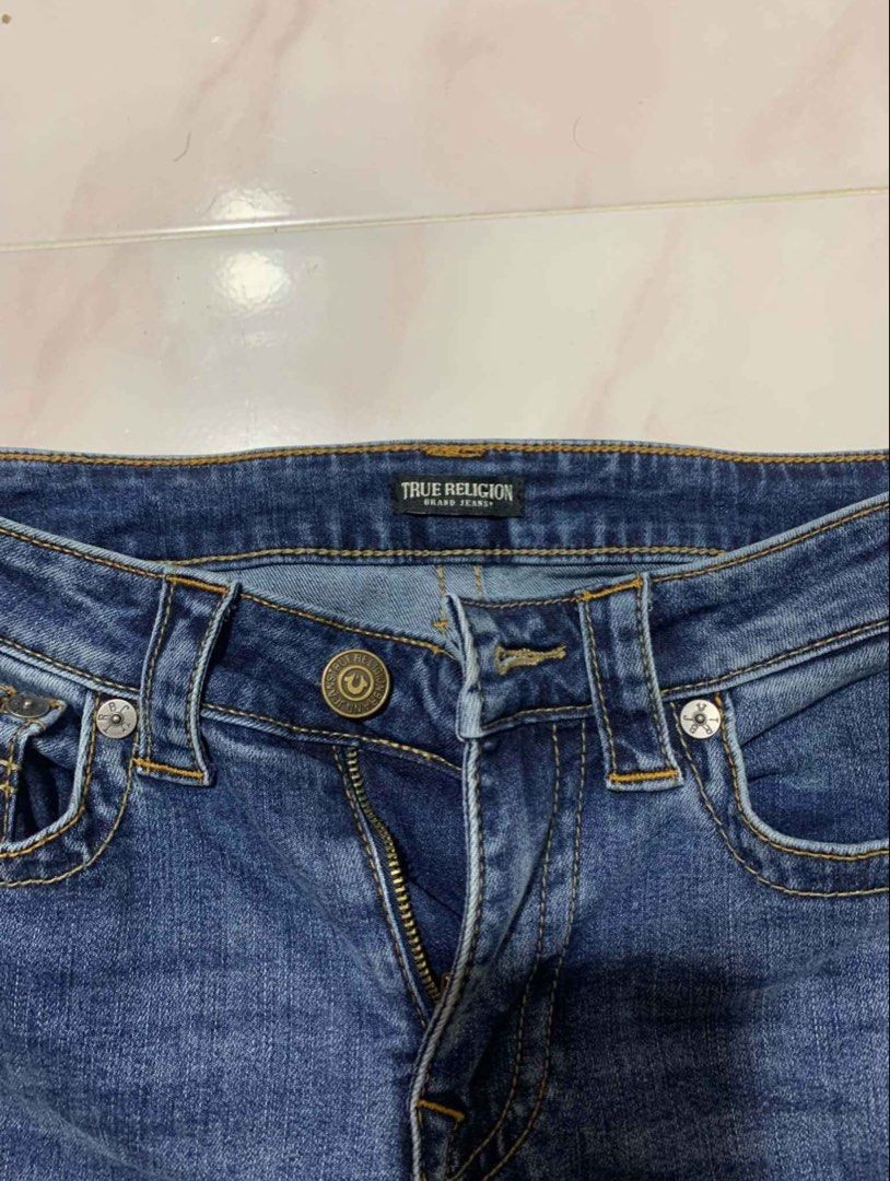 True Religion Boot cut Jeans (Category: Jeans) located in Bacoor. Submitted by migo.o (Listing ID 1466346787, Image 3). Description: - Brand: True Religion -W:27-28 -L:37 -bought it from IG thrift for 800 -rfs: too small - Color/Wash: Blue / Medium wash with slight seam distressing - Fit: Regular fit - Details: Classic horseshoe back pocket stitching, branded metal button closure, zip fly, and leather waist patch - Condition: Great for everyday w