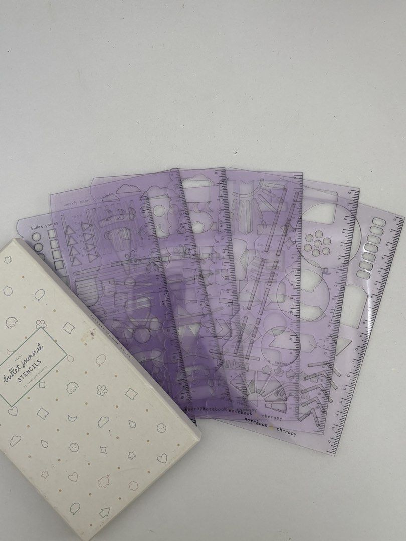 Tsuki Bullet Journal Stencils by Notebook Therapy (Category: Stationery & School Supplies) located in Calamba. Submitted by ealc66554 (Listing ID 1466484166, Image 2). Description: - Brand: Notebook Therapy - Material: Translucent purple plastic - Includes: Multiple templates for bullet points, trackers, banners, and icons - Condition: Comes in original cardboard storage box with cute doodle patterns - Perfect for: Bullet journaling, planners, an