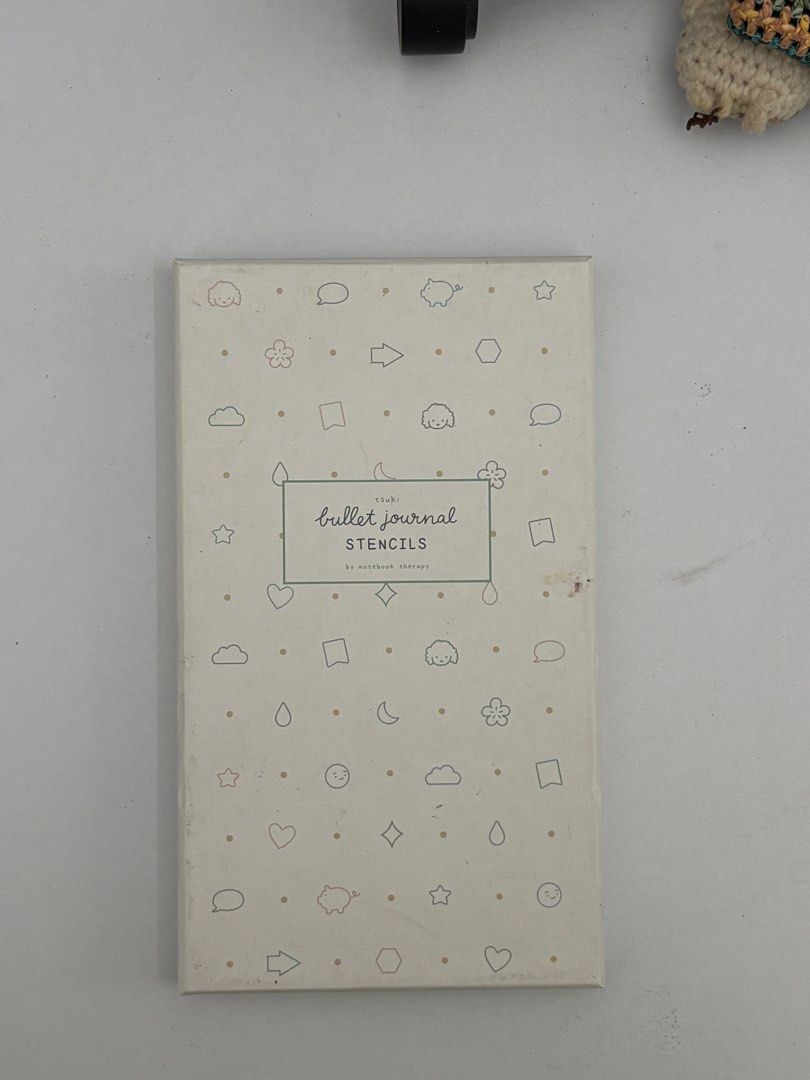 Tsuki Bullet Journal Stencils by Notebook Therapy (Category: Stationery & School Supplies) located in Calamba. Submitted by ealc66554 (Listing ID 1466484166, Image 1). Description: - Brand: Notebook Therapy - Material: Translucent purple plastic - Includes: Multiple templates for bullet points, trackers, banners, and icons - Condition: Comes in original cardboard storage box with cute doodle patterns - Perfect for: Bullet journaling, planners, an