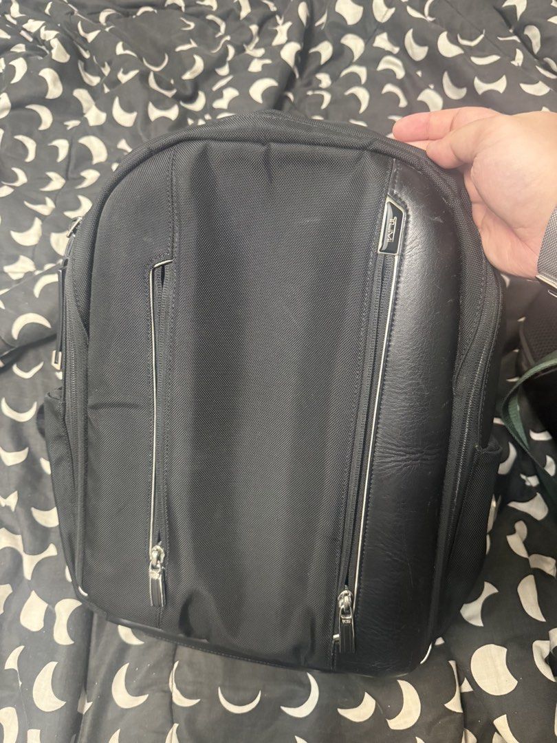 Tumi Arrive Logan Backpack (Category: Backpacks) located in Taytay. Submitted by julesantenor (Listing ID 1466478721, Image 1). Description: Issue is some leather scuffing as seen in the pictures. Also the monogram patch has been engraved. Other than that, backpack is in good condition. Makati location..