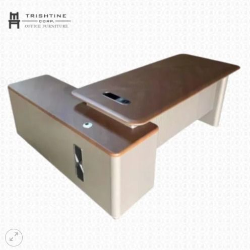 TXT-084 | L-Shape Executive Table (Category: Office Furniture & Fixtures) located in Caloocan City. Submitted by jim.trishtineofficefurnitures (Listing ID 1466404380, Image 1). Description: - Brand: Trishtine Corp Office Furniture - Design: Modern L-shaped executive desk with brown wood-grain top and cream panels - Storage: Includes a matching side storage extension - Convenience: Built-in cable management port for a neat workspace - Condition: E