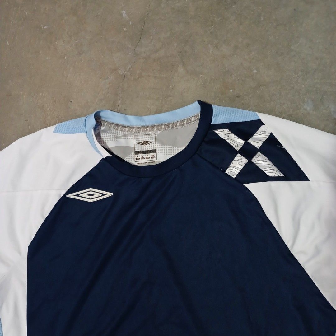 Umbro Evolution X Long Sleeve Sports Shirt (Category: Activewear) located in Manila. Submitted by joefrey12 (Listing ID 1466544192, Image 2). Description: - Brand: Umbro (Evolution X Line) - Color: Navy blue body with white sleeves and light blue accent panels - Size: XL Dimes 23x29 - Material: Lightweight athletic fabric with breathable side mesh panels - Details: Classic Umbro diamond logo on chest, collar tag, and woven 'Evolution X' hem tab -