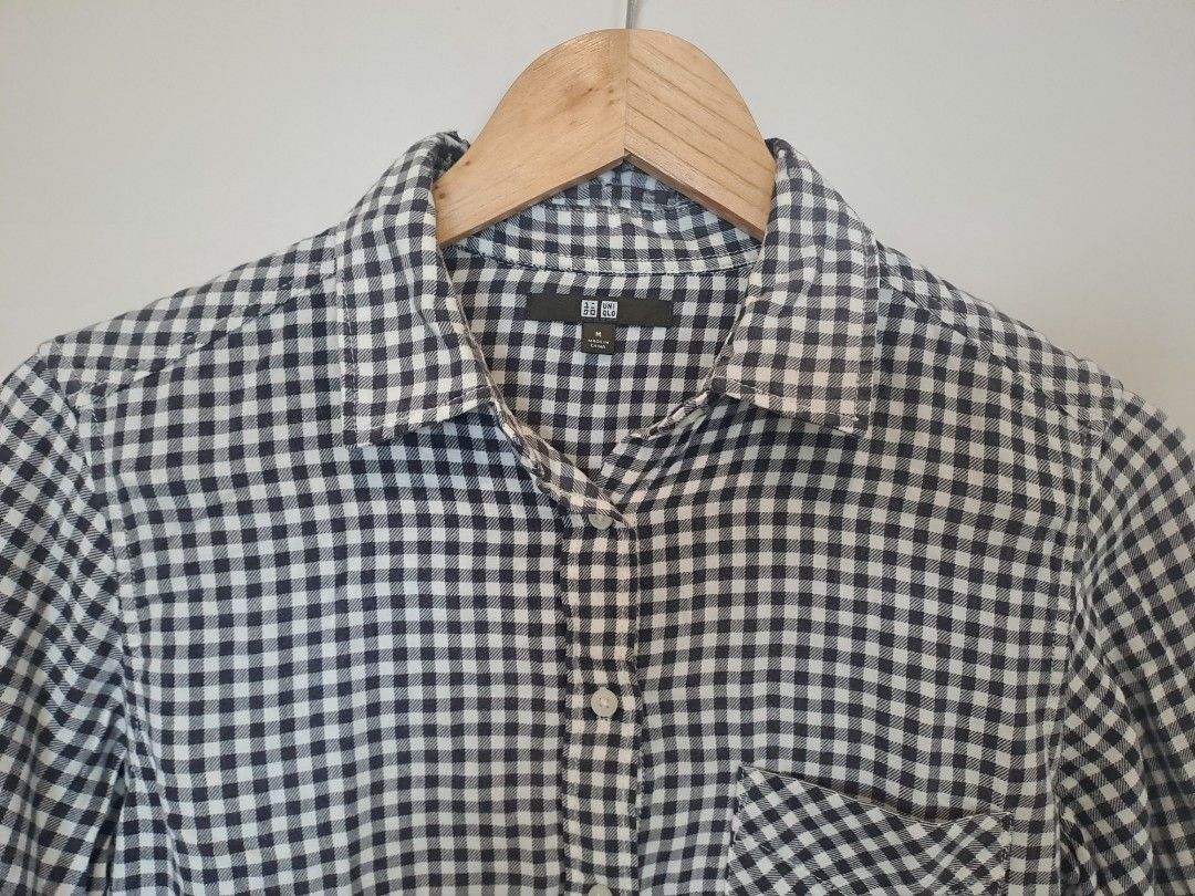 Uniqlo gingham polo longsleve (Category: Longsleeves) located in Manila. Submitted by joanbalde39643 (Listing ID 1466439171, Image 2). Description: This is a UNIQLO women's long-sleeve gingham button-down shirt. It features a classic black and white checkered pattern, a standard collar, a single left chest pocket, and a curved hemline..