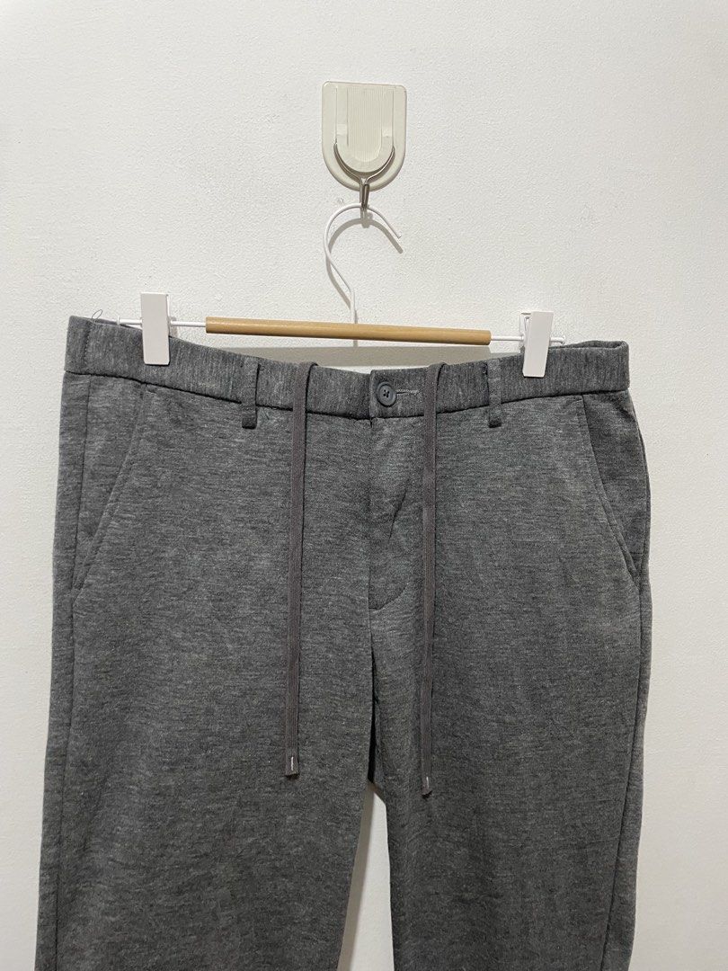 Uniqlo Grey Jogger Pants Size L (Category: Joggers) located in Makati City. Submitted by nicolettel27186 (Listing ID 1466517010, Image 2). Description: - Brand: Uniqlo - Size: L - Color: Grey - Material: Soft jersey - Waistband: Elastic with drawstring closure, belt loops, and front zip - Pockets: Blue and white striped pocket lining, back welt pockets with button closures - Hem: Ribbed cuffs at the ankles - Condition: Excellent.