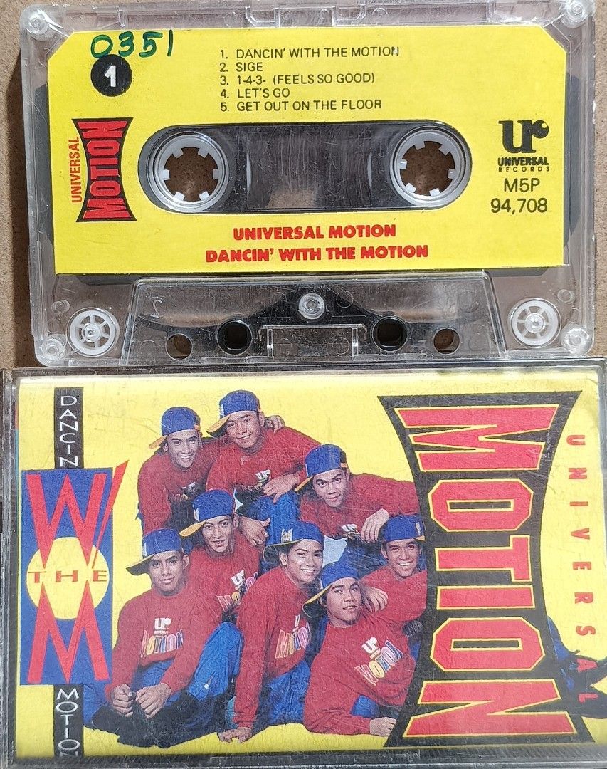 Universal Motion Dancin' With The Motion Cassette Tape (Category: CDs & DVDs) located in Manila. Submitted by ruelcabrer77078 (Listing ID 1466527310, Image 2). Description: - Artist: Universal Motion Dancers - Format: Original cassette tape (Universal Records, M5P 94,708) - Notable Tracks: Dancin' With The Motion, Sige, 1-4-3- (Feels So Good), Let's Go, Get Out On The Floor - Design: Clear cassette shell with yellow tracklist insert and photo J-c