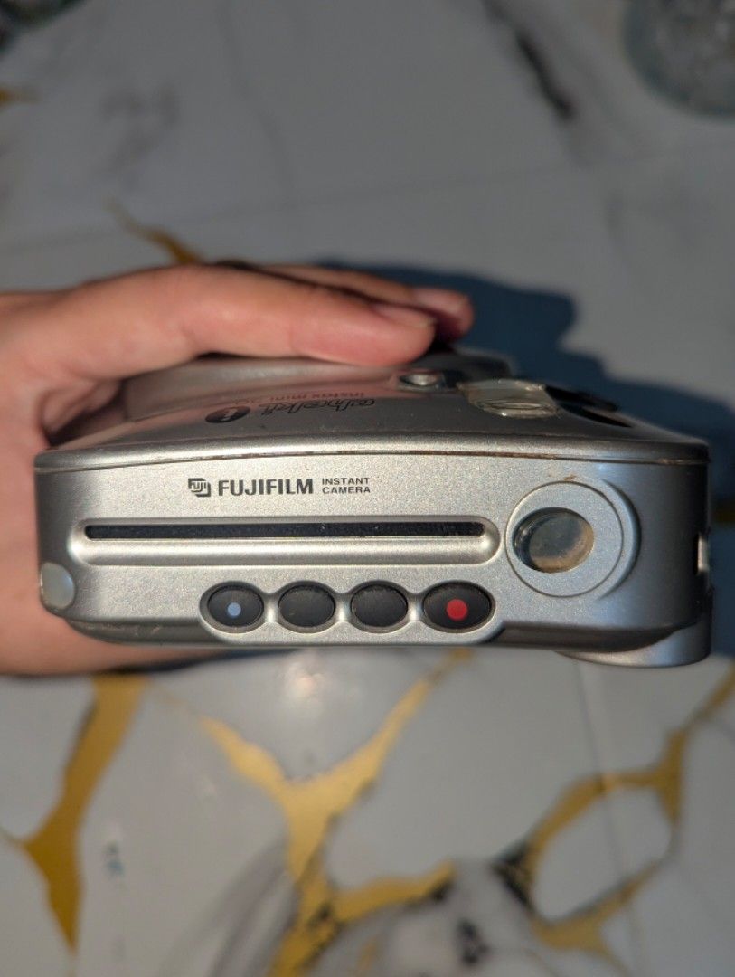 UNTESTED Fujifilm Instax Mini 30 Cheki Silver Instant Camera (Category: Cameras) located in Guiguinto. Submitted by matcha.designs (Listing ID 1466502721, Image 3). Description: - Model: Silver Fujifilm Instax Mini 30 instant film camera - Features: Compact square body, built-in flash, optical viewfinder - Film & Power: Uses Instax Mini instant film and standard CR2 batteries - Focus: Lens focal range from 0.6m to infinity - Condition: Tested, me