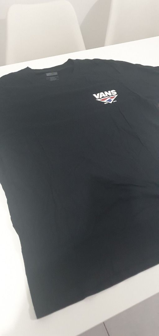 Vans Black Graphic T-Shirt (Category: Tshirts & Polo Shirts ) located in Quezon City. Submitted by sk8ter13 (Listing ID 1466439453, Image 2). Description: - Brand: Vans - Color: Solid Black - Size: Extra Large (XL) - Fit: Short sleeve, comfortable daily wear - Details: Small chest logo graphic near left collar - Comfort: Tagless design with instructions printed inside collar - Condition: Clean surface, great skate style.