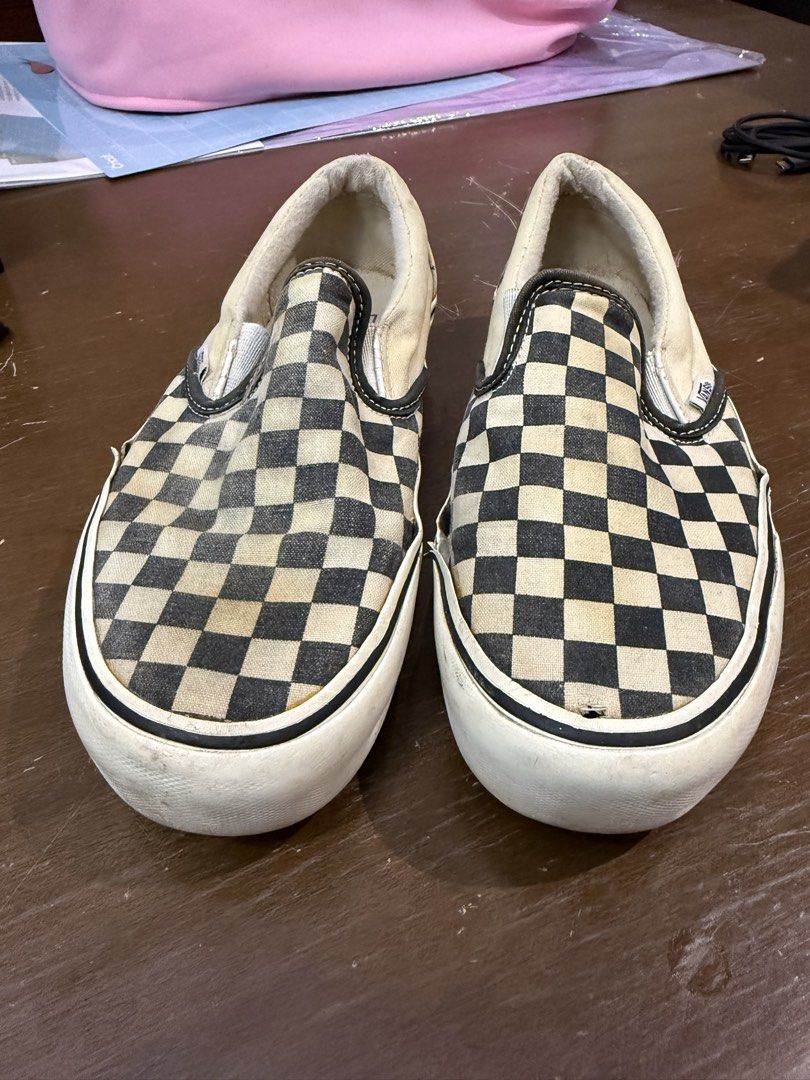 Vans Classic Checkerboard Slip-On (Category: Sneakers) located in Quezon City. Submitted by nsseller (Listing ID 1466460427, Image 1). Description: - Item: Vans Classic Checkered Slip-Ons - Color: Black and White - Size: Men's US 7 / Women's US 8.5 - Condition: Heavy wear with all-over fading, yellowing on soles/fabric, and a small tear on the right toe box - Ideal Use: Perfect everyday beaters or skate shoes - Price: Budget-friendly, priced to s