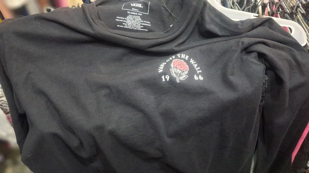 Vans Off The Wall Rose Long Sleeve Tee (Category: Tshirts & Polo Shirts ) located in Caloocan City. Submitted by domags (Listing ID 1466470779, Image 1). Description: - Brand: Vans Off The Wall - Color: Black - Size: Small - Design: Small rose graphic on front chest; large rose, hand graphic, and 1966 branding on the back - Neckline: Crew neck - Material: Comfortable, high-quality cotton - Style: Easy to match with any everyday casual outfit.