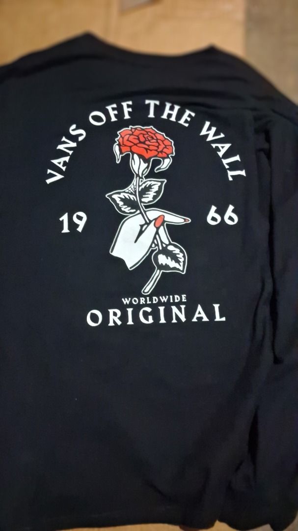 Vans Off The Wall Rose Long Sleeve Tee (Category: Tshirts & Polo Shirts ) located in Caloocan City. Submitted by domags (Listing ID 1466470779, Image 2). Description: - Brand: Vans Off The Wall - Color: Black - Size: Small - Design: Small rose graphic on front chest; large rose, hand graphic, and 1966 branding on the back - Neckline: Crew neck - Material: Comfortable, high-quality cotton - Style: Easy to match with any everyday casual outfit.