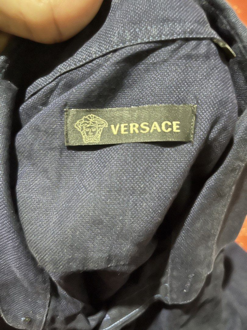 Versace Navy Long Sleeve Button Down Shirt (Category: Formal Shirts) located in Manila. Submitted by manonghits.12 (Listing ID 1466463828, Image 2). Description: - Brand: Versace - Color: Dark navy blue - Style: Long sleeve button-down shirt with classic collar and button cuffs - Detail: Subtle tonal Medusa logo embroidered on the left chest - Material: Lightweight fabric - Versatility: Perfect for office styling or smart casual wear 550+sf only 
