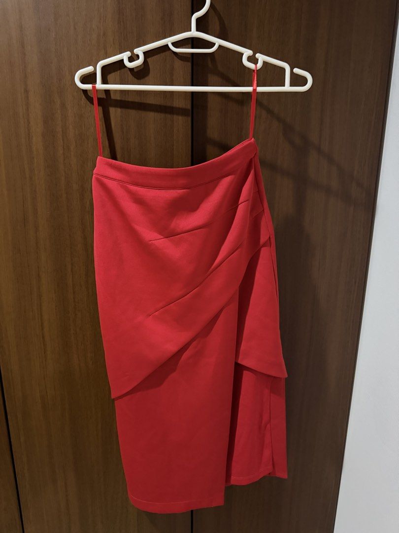 Vibrant Red Asymmetrical Wrap Skirt (Category: Skirts) located in Cebu City. Submitted by prelovedbymecebu (Listing ID 1466337148, Image 1). Description: - Color: Bright red - Design: Asymmetrical layered tiers with a flattering front drape - Features: Structured fabric that holds its shape, thin spaghetti straps at the waistband - Condition: Worn a couple of times, still looks fresh and vibrant - Perfect for: Casual outings or parties.