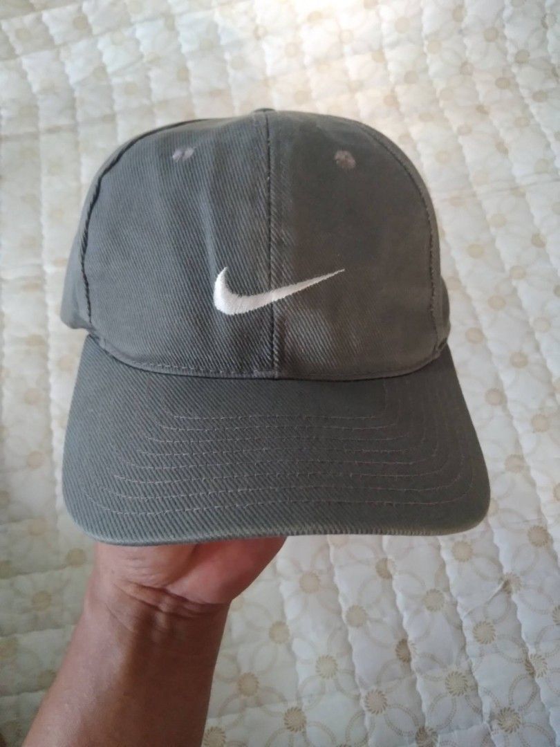 Vintage 90's Nike Cap Adjustable Strap (Category: Caps & Hats) located in Zamboanga. Submitted by nurbya898048 (Listing ID 1466456639, Image 1). Description: Vintage 90's Nike baseball cap with a white embroidered swoosh on the front. Plastic snapback closure at the back, fully adjustable. Classic six-panel design with embroidered eyelets for breathability. Great everyday hat, goes with pretty much any casual outfit. Clean and ready to wear..