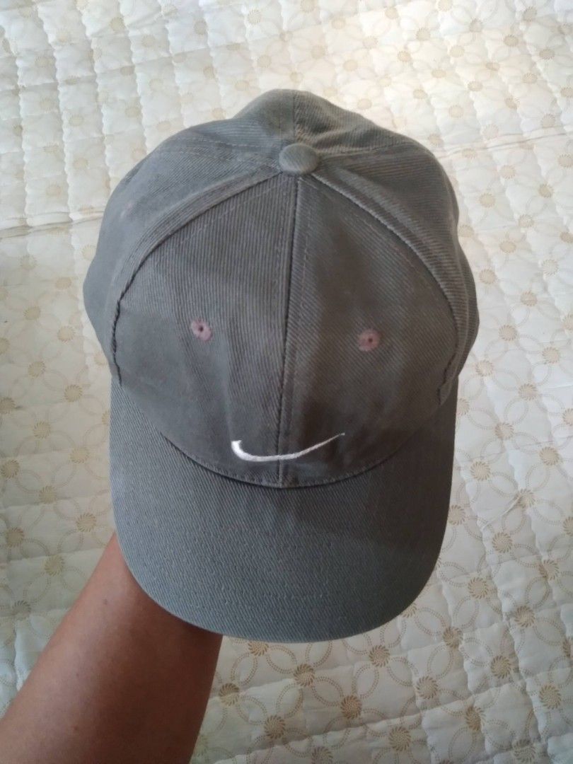 Vintage 90's Nike Cap Adjustable Strap (Category: Caps & Hats) located in Zamboanga. Submitted by nurbya898048 (Listing ID 1466456639, Image 2). Description: Vintage 90's Nike baseball cap with a white embroidered swoosh on the front. Plastic snapback closure at the back, fully adjustable. Classic six-panel design with embroidered eyelets for breathability. Great everyday hat, goes with pretty much any casual outfit. Clean and ready to wear..