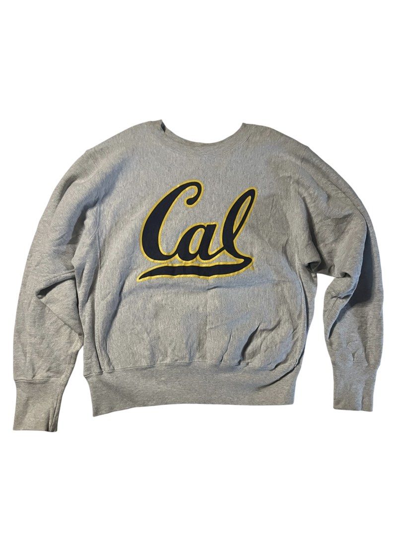 Vintage Cal Berkeley Grey Crewneck Sweatshirt (Category: Coats, Jackets and Outerwear) located in Manila. Submitted by matik6 (Listing ID 1466541922, Image 1). Description: Grey college crewneck sweatshirt. Large Cal script logo across the chest in navy blue with yellow outline. Heavyweight ribbing at the cuffs, collar, and hem. Relaxed, classic fit. Solid grey back..