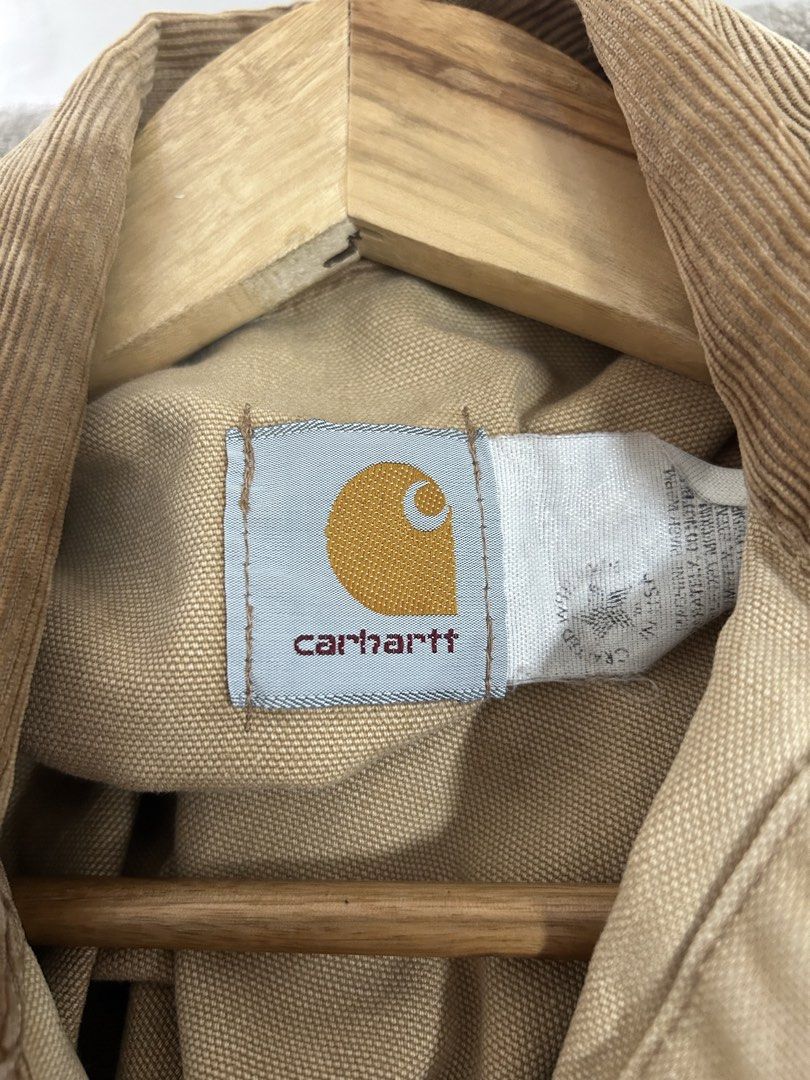 Vintage Carhartt 1989 Chore Jacket (Category: Coats, Jackets and Outerwear) located in Los Banos. Submitted by remynextdoor (Listing ID 1466392216, Image 3). Description: - Brand: Carhartt - 23.5x26 - Style: Vintage 100 Years (1889-1989) Canvas Chore Jacket - Color: Tan with contrast brown corduroy collar, pocket flaps, and cuffs - Details: Special commemorative stamped metal buttons and multiple front utility pockets - Sizing: Flat lay width mea