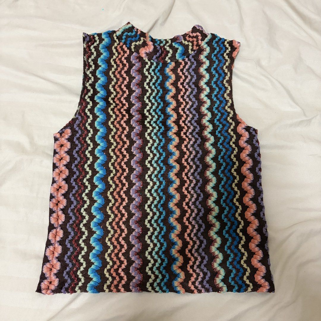 Vintage Chevron Pattern Sleeveless Knit Top (Category: Sleeveless) located in Mandaluyong City. Submitted by afterceej (Listing ID 1466472802, Image 1). Description: - Retro zigzag knit top with a vibrant multicolored chevron pattern - Colors include brown, bright blue, peach, mint, and purple - Sleeveless cut with a chic high neckline - Lightweight, textured fabric featuring subtle metallic threading - Versatile statement piece great for layerin