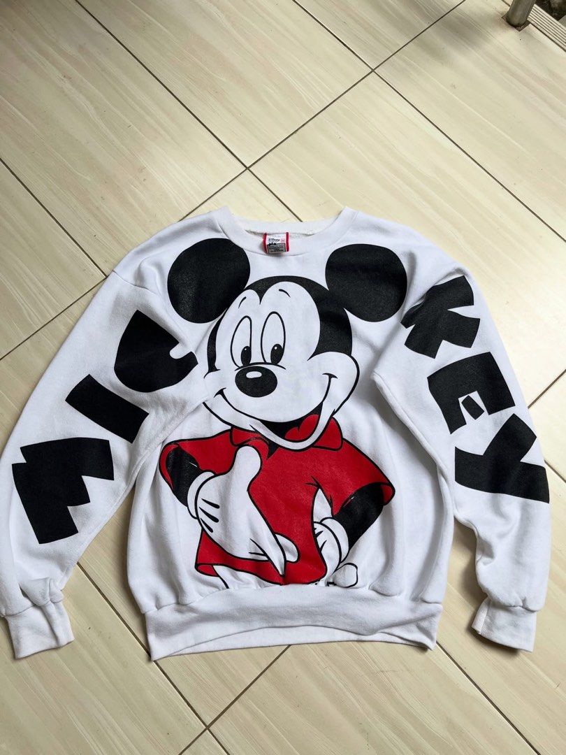 Vintage Disney Mickey Mouse White Oversized Sweatshirt Large (Category: Coats, Jackets and Outerwear) located in Manila. Submitted by thrifted.shits (Listing ID 1466496656, Image 1). Description: Vintage white Disney Mickey Mouse sweatshirt, size L. Features large front and back graphics with lettered sleeves. Made in USA.