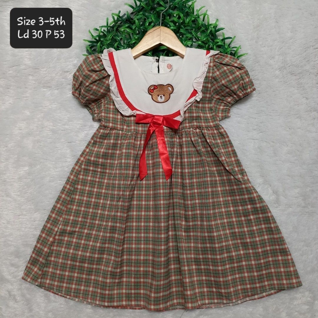 Vintage dress (Category: Babies & Kids Fashion) located in Manila. Submitted by carolgaza14 (Listing ID 1466439496, Image 1). Description: Kids Plaid Dress with Bear Collar - Size 5-6T - *Pattern:Green, red, and beige small checkered plaid / gingham - *Cut:* Short puff sleeves, A-line flare skirt, regular fit - *Collar:* Large white sailor / bib collar with red piping and white ruffle trim - With cute embroidered brown teddy bear with red bows in