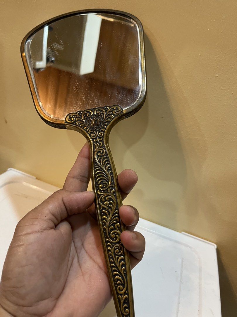Vintage Handheld Vanity Mirror with Classical Art Print (Category: Mirrors) located in Dasmarinas. Submitted by emmakim08 (Listing ID 1466336783, Image 2). Description: - Vintage hand mirror featuring a classic 18th-century art print on the back - Ornate gold-tone metal frame and handle with intricate scrollwork and floral relief - Clear, high-quality reflective glass on the front - Standard vanity size, ideal for dressers or vanity tables - Cond