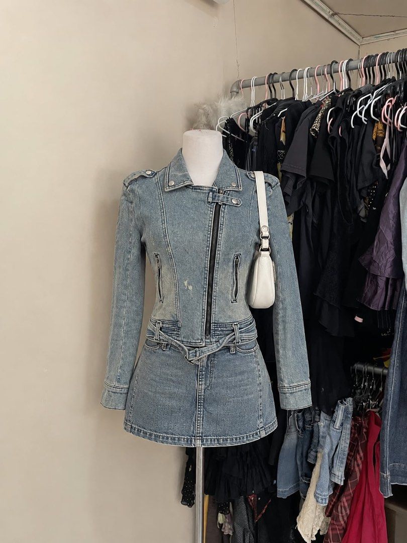 Vintage Light Wash Denim Biker Jacket (Category: Coats, Jackets and Outerwear) located in Cagayan de Oro. Submitted by prelovedbynmei (Listing ID 1466563314, Image 1). Description: - Style: Moto biker denim jacket - Wash: Light wash blue with distressed details - Closure: Asymmetrical front zipper - Collar: Lapel collar with snap buttons - Pockets: Functional zippered front pockets - Details: Integrated belt with buckle at the hem and shoulder ep