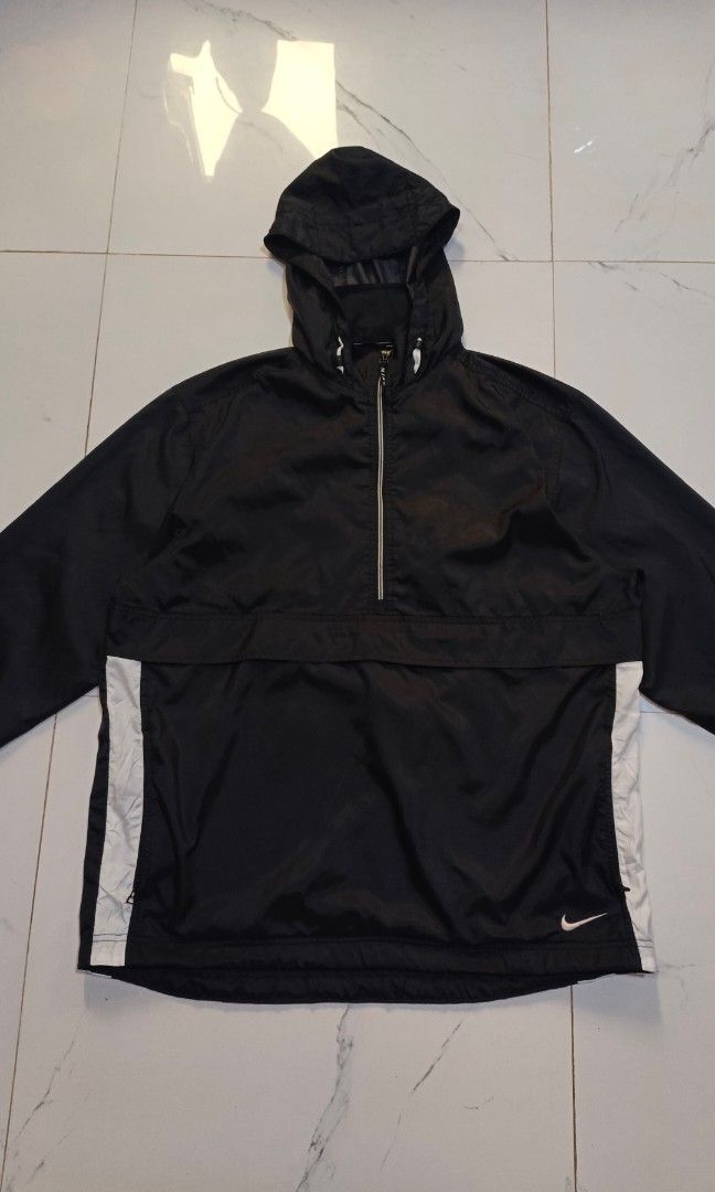 Vintage Nike Half-Zip Anorak Jacket (Category: Coats, Jackets and Outerwear) located in Canlaon. Submitted by thriftytrift (Listing ID 1466405081, Image 2). Description: Size: L Nylon shell | Made in Sri Lanka Condition: [e.g. 9/10, no holes or stains] Embroidered white Nike swoosh on the lower front Half-zip with the "NIKE" zip pull Large front kangaroo pocket with a zip Velcro cuff straps Mesh-lined body, nylon-lined hood Red swoosh Nike neck t