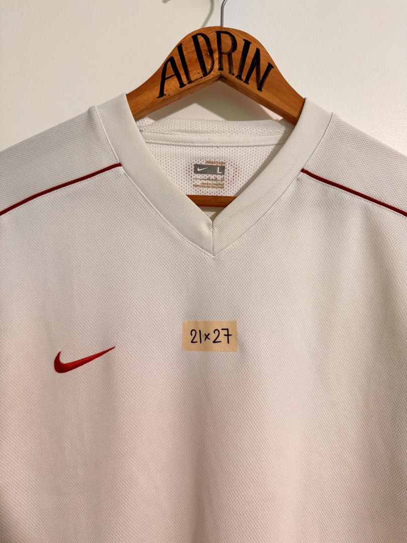 Vintage Nike White Red Jersey Size L (Category: Activewear) located in Cavite. Submitted by aldrindela40142 (Listing ID 1466536765, Image 2). Description: - Brand: Nike - Color: White with striking red piping - Size: L (21" pit to pit x 27" length) - Features: Large number graphic on the back, small Nike logo on chest, Nike FIT tech label - Material: Clean, breathable mesh texture all over - Condition: Excellent, clean condition.
