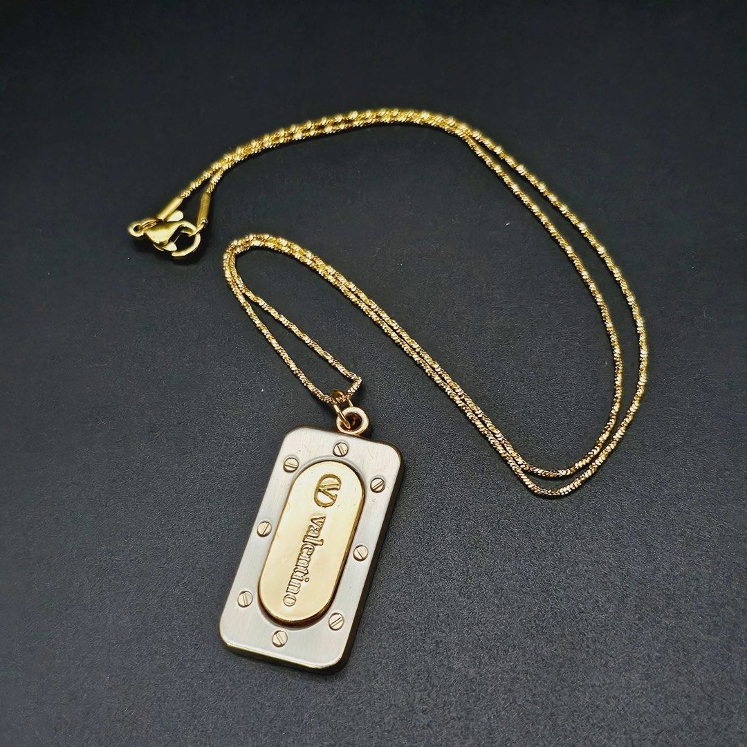 VINTAGE VALENTINO TAG NECKLACE ✨ (Category: Necklaces) located in Mandaluyong City. Submitted by luxprelovedbagsparadise (Listing ID 1466451709, Image 3). Description: ✨ VINTAGE VALENTINO TAG NECKLACE ✨ A timeless vintage piece with that effortlessly classy, statement-making look. 🤎✨ 💛 Gold-Plated Finish 🔲 Rectangular Tag Pendant ✨ Engraved Valentino Brand 🔩 Signature Flathead Screw Details 🕰️ Vintage Design 📦 ON HAND & READY TO SHIP 🔥 STE
