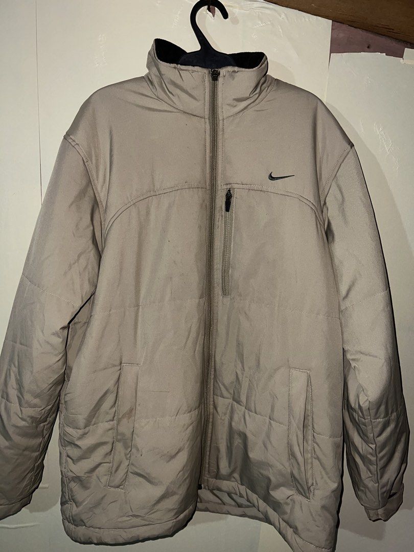 Vintage Y2K Nike Beige Full-Zip Puffer Jacket (Category: Coats, Jackets and Outerwear) located in Manila. Submitted by street_stitch777 (Listing ID 1466522973, Image 1). Description: - Brand: Nike - Era: Y2K / Early 2000s vintage - Size: Men's XL just M on tav - Color: Beige / Neutral earth tone - Details: Embroidered small black swoosh logo, zip chest pocket, lower hand pockets, and adjustable drawstring hem - Style: Full-zip puffer jacket, perf