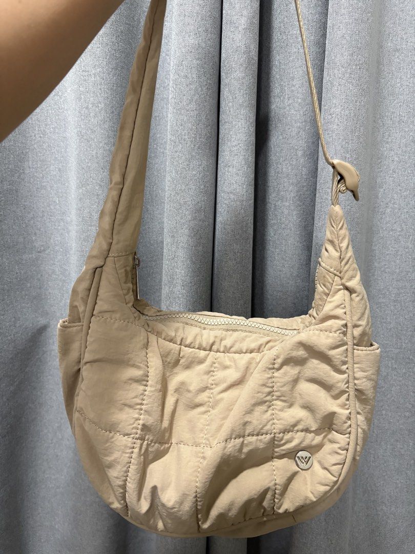 Westbronco bag (Category: Shoulder Bags) located in Mandaluyong City. Submitted by annab11 (Listing ID 1466561747, Image 2). Description: - Color: Versatile neutral beige - Material: Durable nylon with soft quilted panels - Hardware & Strap: Adjustable strap with secure plastic buckle - Compartments: Front zipper pocket and spacious main top zip closure - Details: Subtle logo badge near the bottom corner - Style: Perfect everyday bag that matches