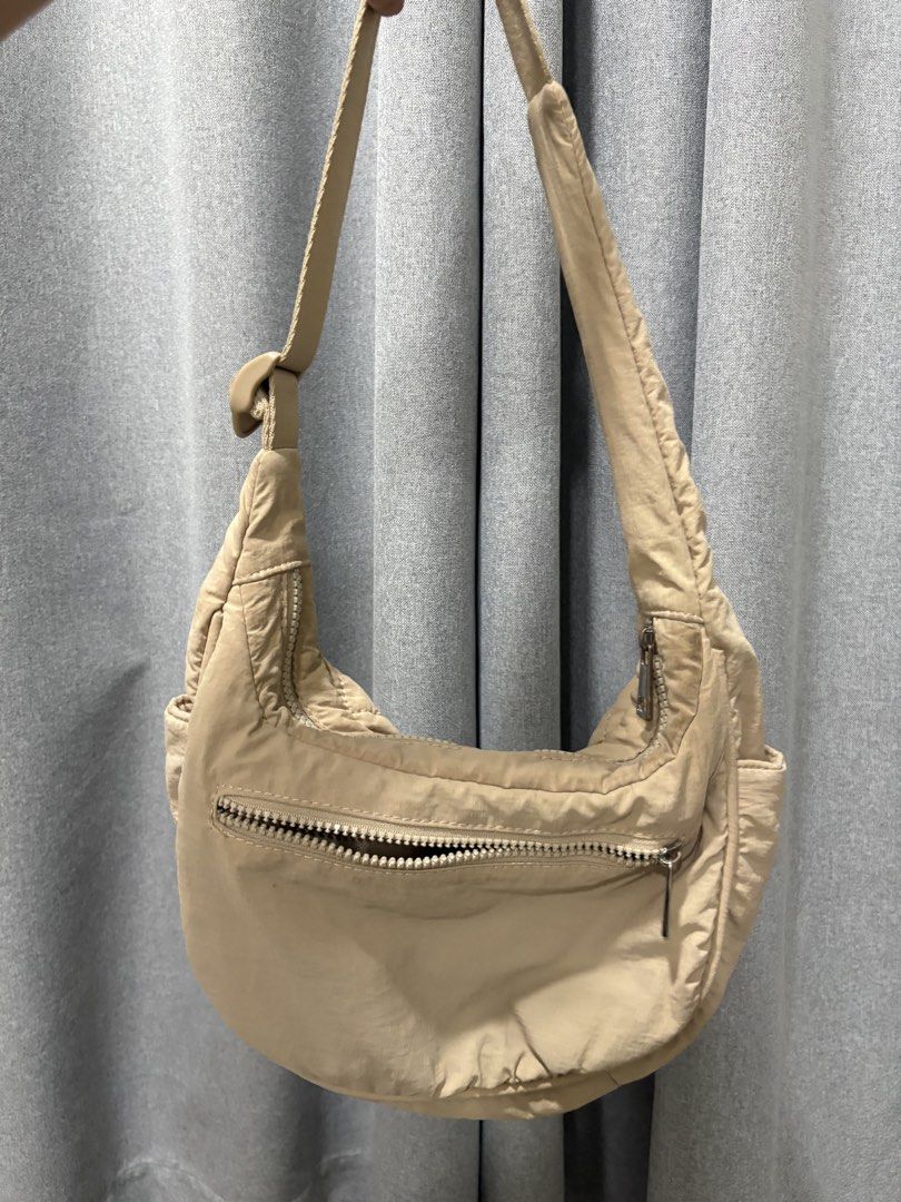 Westbronco bag (Category: Shoulder Bags) located in Mandaluyong City. Submitted by annab11 (Listing ID 1466561747, Image 1). Description: - Color: Versatile neutral beige - Material: Durable nylon with soft quilted panels - Hardware & Strap: Adjustable strap with secure plastic buckle - Compartments: Front zipper pocket and spacious main top zip closure - Details: Subtle logo badge near the bottom corner - Style: Perfect everyday bag that matches