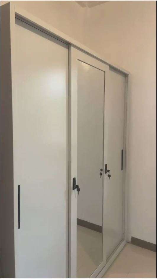 White 3-Door Wardrobe with Hanging Rails and Lockable Compartment (Category: Shelves, Cabinets & Racks) located in Caloocan City. Submitted by swiftdolphin.2aa81b (Listing ID 1466355822, Image 1). Description: White metal or wooden wardrobe setup. Two sections include clothes hanging rails with top and bottom shelves. Middle section has a bottom drawer. Right section features multiple open shelves plus a small lockable compartment with keys. Clea