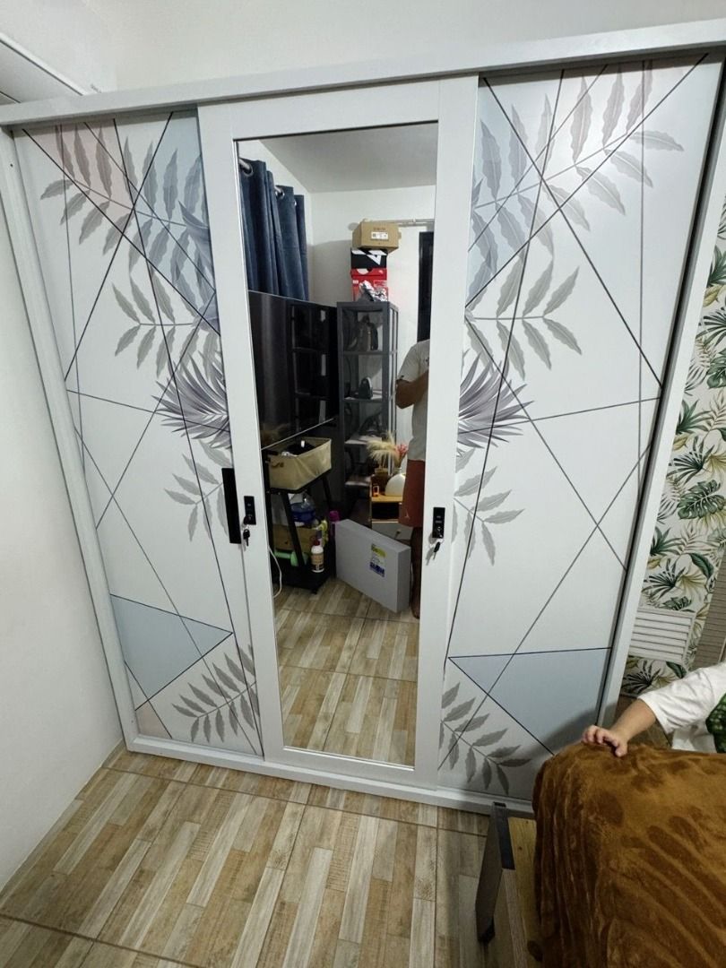 White 3-Door Wardrobe with Hanging Rails and Lockable Compartment (Category: Shelves, Cabinets & Racks) located in Caloocan City. Submitted by swiftdolphin.2aa81b (Listing ID 1466355822, Image 2). Description: White metal or wooden wardrobe setup. Two sections include clothes hanging rails with top and bottom shelves. Middle section has a bottom drawer. Right section features multiple open shelves plus a small lockable compartment with keys. Clea