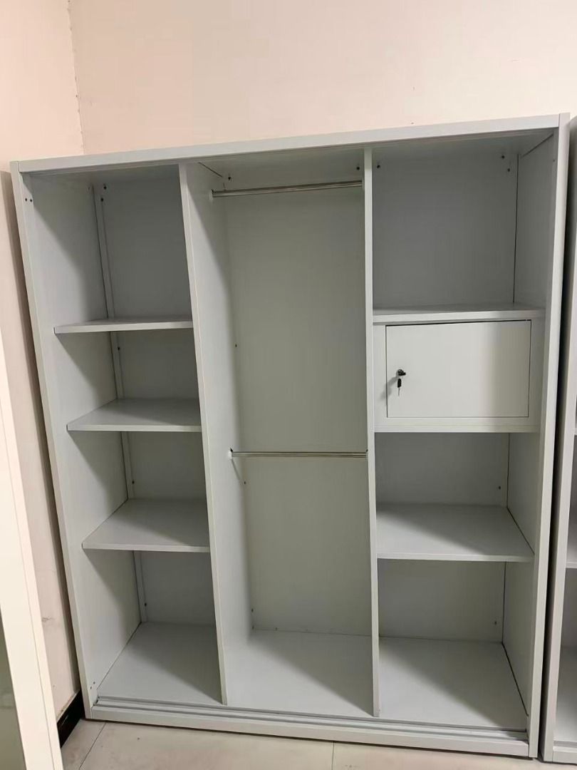White 3-Door Wardrobe with Hanging Rails and Lockable Compartment (Category: Shelves, Cabinets & Racks) located in Caloocan City. Submitted by swiftdolphin.2aa81b (Listing ID 1466355822, Image 3). Description: White metal or wooden wardrobe setup. Two sections include clothes hanging rails with top and bottom shelves. Middle section has a bottom drawer. Right section features multiple open shelves plus a small lockable compartment with keys. Clea