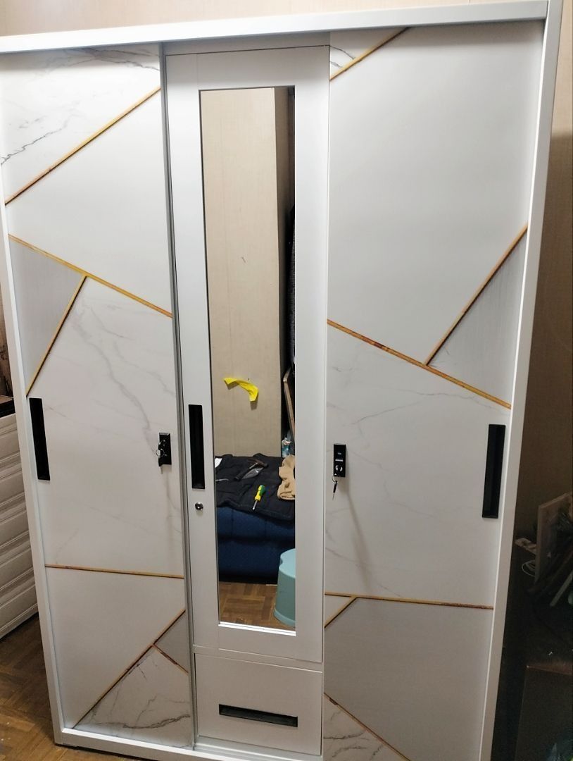 White 3-Section Wardrobe with Hanging Rods and Lockable Compartment (Category: Shelves, Cabinets & Racks) located in Caloocan City. Submitted by swiftdolphin.2aa81b (Listing ID 1466356047, Image 2). Description: White metal or wooden wardrobe setup. Two sections include clothes hanging rails with top and bottom shelves. Middle section has a bottom drawer. Right section features multiple open shelves plus a small lockable compartment with keys. Cl