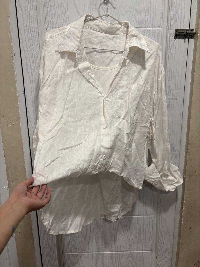 White Button-Up Shirt with Attached Inner Tank Top (Category: Shirts) located in Mandaluyong City. Submitted by shopwithjuu (Listing ID 1466421911, Image 2). Description: White oversized button-up shirt with a built-in inner tank top layer. Features a relaxed fit, classic collar, chest pocket, and high-low hem. Lightweight and perfect for casual everyday layering..