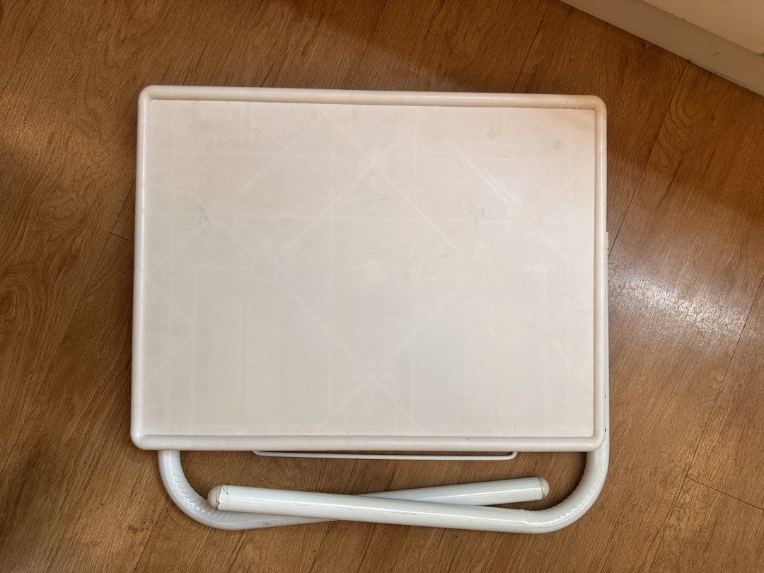 White foldable plastic study table TV tray (Category: Tables & Sets) located in Quezon City. Submitted by k_prelovedpieces (Listing ID 1466395227, Image 2). Description: - Color: White with sturdy metal legs - Design: Foldable for easy storage - Size: Compact, ideal for small rooms, balconies, or bedside use - Condition: Light surface marks from regular usage, structure is 100% sturdy - Multi-purpose: Great for studying, eating, or working on lap