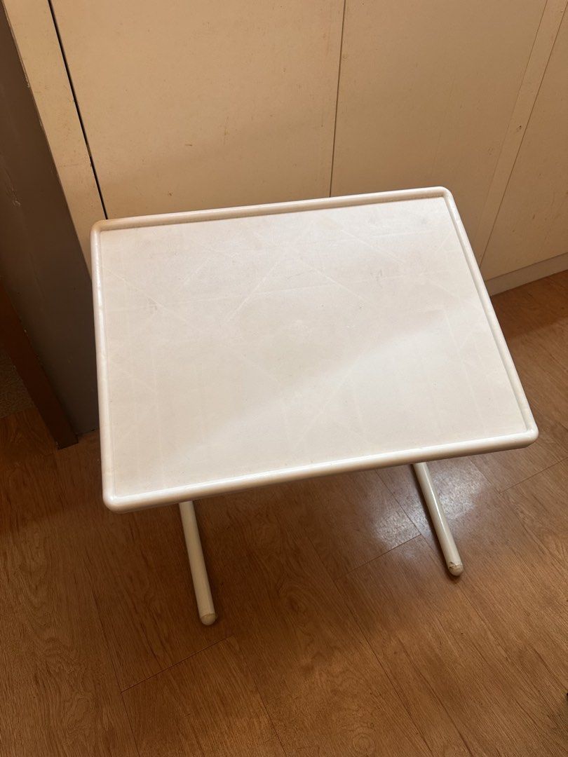 White foldable plastic study table TV tray (Category: Tables & Sets) located in Quezon City. Submitted by k_prelovedpieces (Listing ID 1466395227, Image 3). Description: - Color: White with sturdy metal legs - Design: Foldable for easy storage - Size: Compact, ideal for small rooms, balconies, or bedside use - Condition: Light surface marks from regular usage, structure is 100% sturdy - Multi-purpose: Great for studying, eating, or working on lap